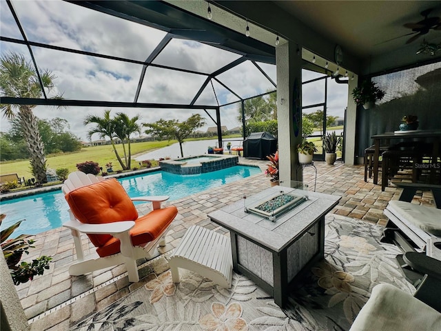 view of swimming pool with a pool with connected hot tub, a patio, and a lanai