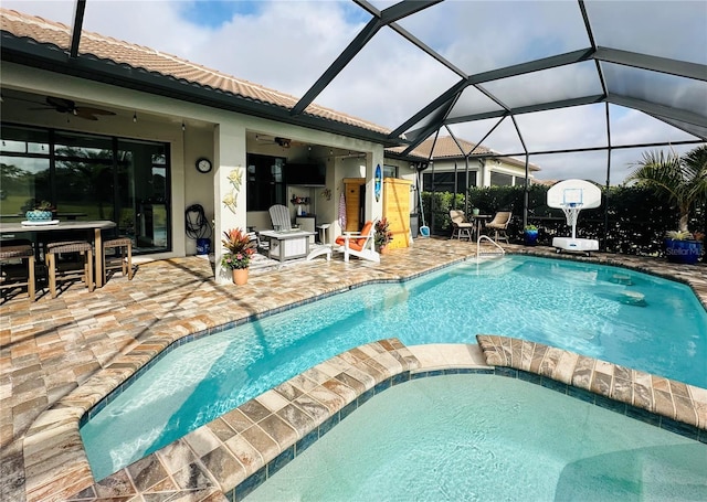 view of pool with ceiling fan, a patio, a lanai, and a pool with connected hot tub