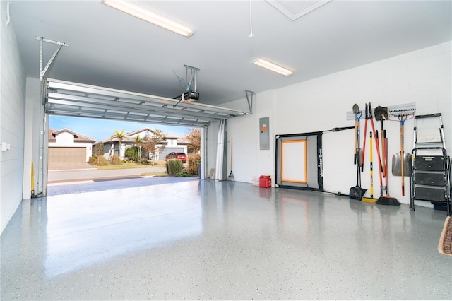 garage featuring a garage door opener and electric panel