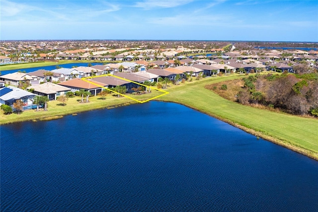 drone / aerial view with a water view and a residential view