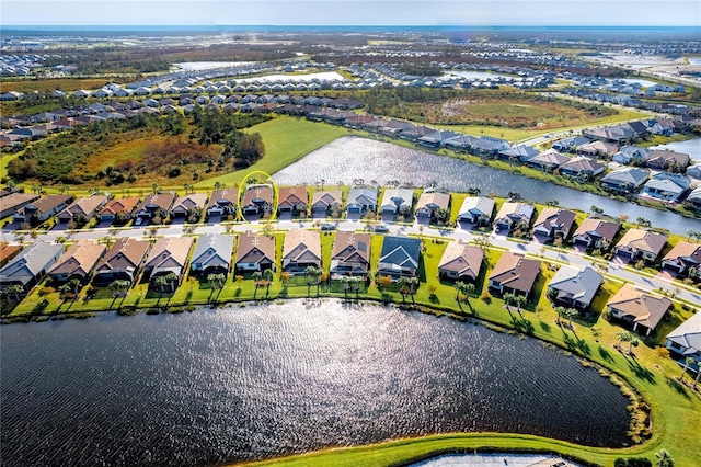 birds eye view of property featuring a water view and a residential view