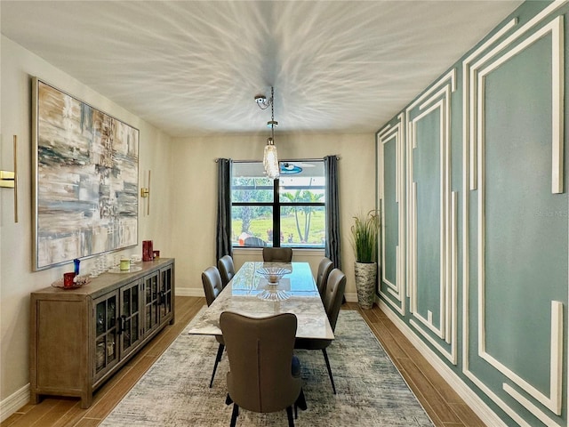 dining area featuring wood finished floors and baseboards