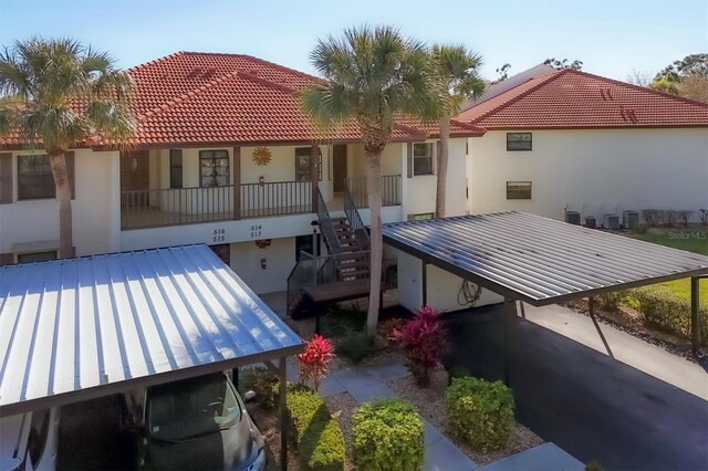 514 Pine Hollow Cir Unit 514, Englewood, FL 34223 - back of property with stairs and stucco siding