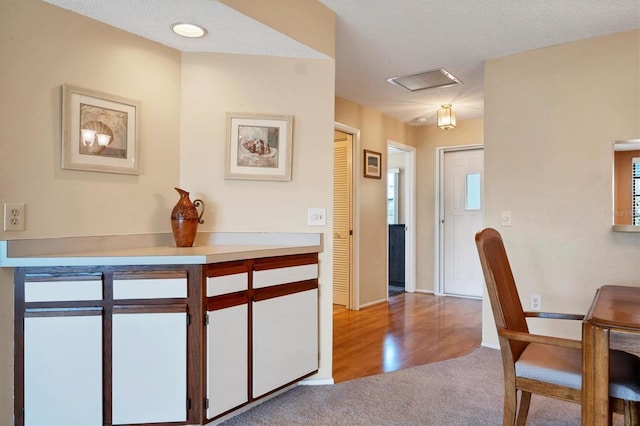 interior space with plenty of natural light, a textured ceiling, and light hardwood / wood-style flooring