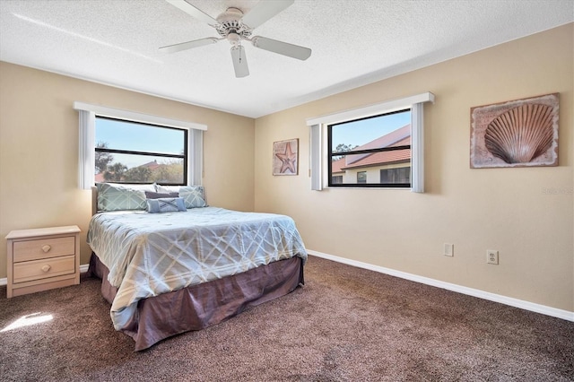 bedroom featuring carpet, ceiling fan, and a textured ceiling