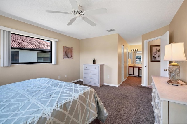 carpeted bedroom with ceiling fan and a textured ceiling