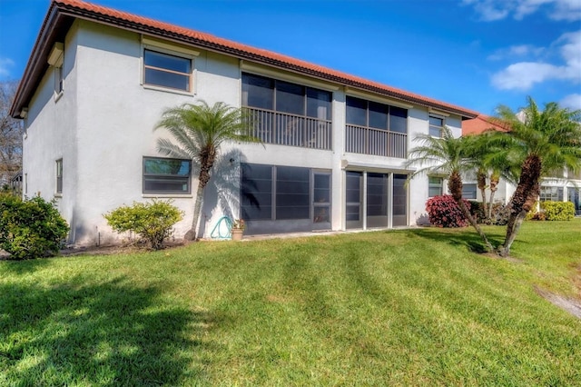 514 Pine Hollow Cir Unit 514, Englewood, FL 34223 - rear view of house with stucco siding and a yard