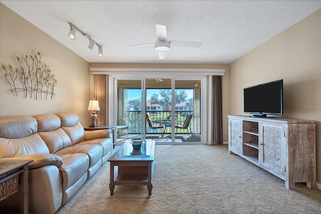 living room with carpet flooring, a textured ceiling, track lighting, and ceiling fan