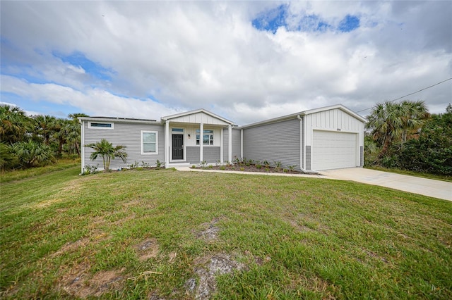 19196 Raymond Ave, Port Charlotte, FL 33954 - view of front of house featuring board and batten siding, a front lawn, and driveway