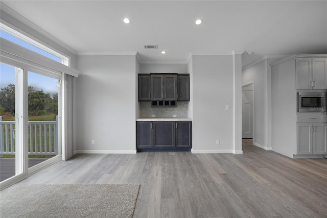 19196 Raymond Ave, Port Charlotte, FL 33954 - unfurnished living room featuring light wood-type flooring, ornamental molding, baseboards, and recessed lighting