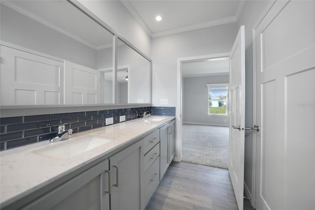 19196 Raymond Ave, Port Charlotte, FL 33954 - full bathroom with wood finished floors, double vanity, decorative backsplash, crown molding, and recessed lighting