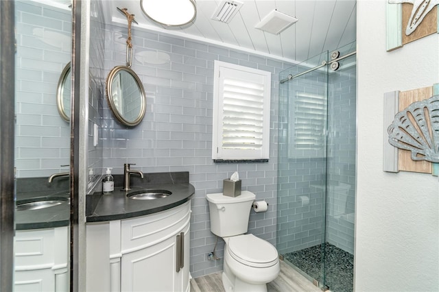 bathroom featuring vanity, toilet, walk in shower, and hardwood / wood-style floors