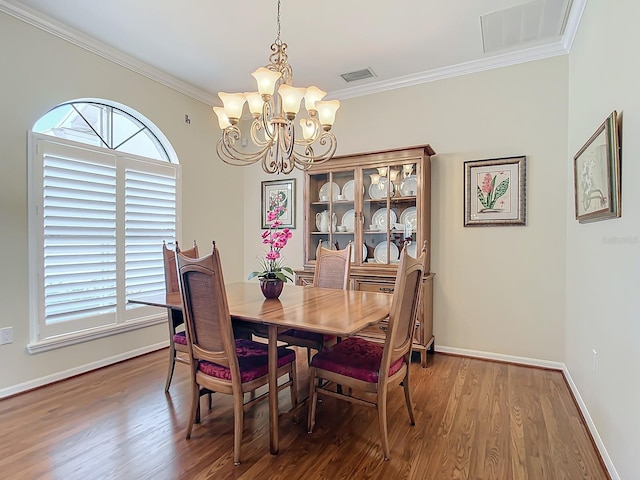 dining area featuring wood-type flooring, ornamental molding, and a chandelier