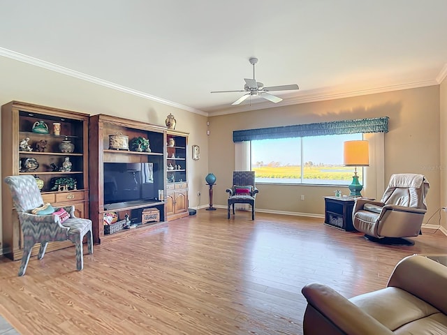 living room featuring ornamental molding, hardwood / wood-style floors, and ceiling fan