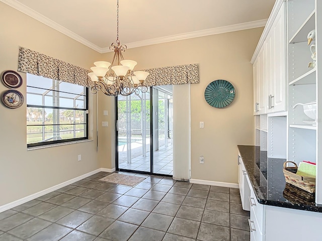 doorway with crown molding, an inviting chandelier, and dark tile patterned floors