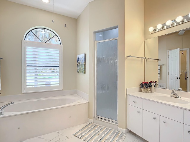 bathroom with vanity and shower with separate bathtub