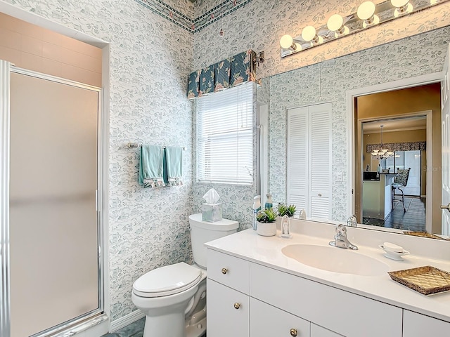 bathroom featuring vanity, toilet, and walk in shower