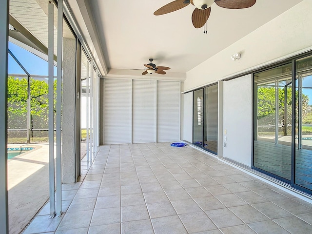 unfurnished sunroom featuring ceiling fan