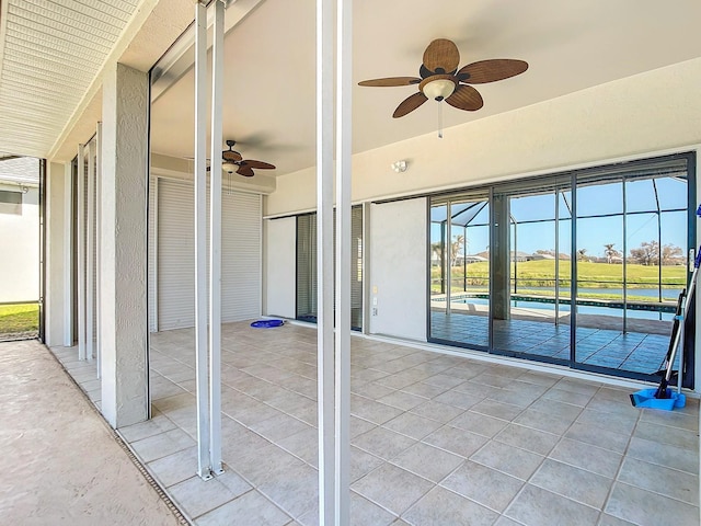 unfurnished sunroom with a wealth of natural light and ceiling fan