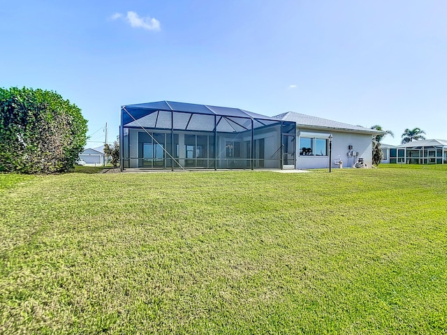 back of house featuring glass enclosure and a lawn