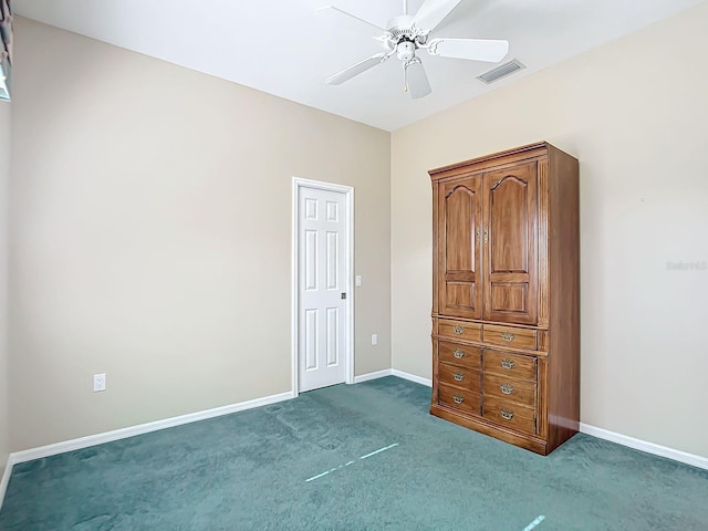 unfurnished bedroom featuring dark colored carpet and ceiling fan