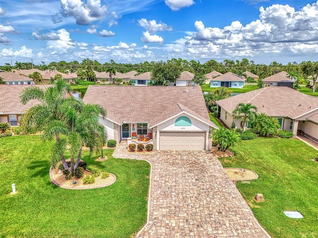 view of front of property featuring a front yard and a garage