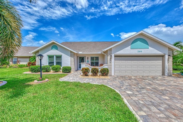 ranch-style home featuring a front lawn and a garage