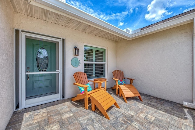 doorway to property with a patio