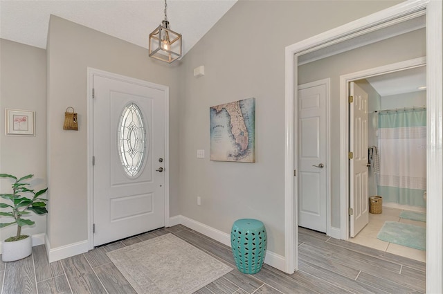 entryway featuring vaulted ceiling and a textured ceiling