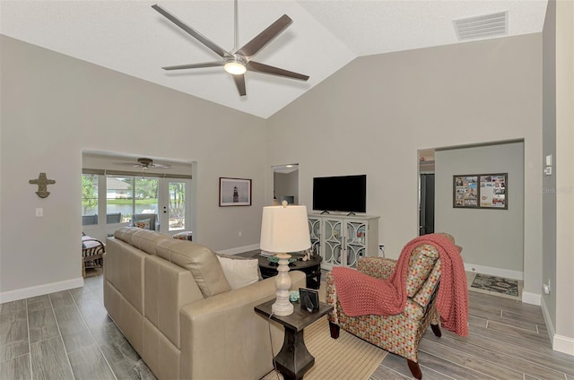 living room featuring french doors, light hardwood / wood-style flooring, high vaulted ceiling, and ceiling fan