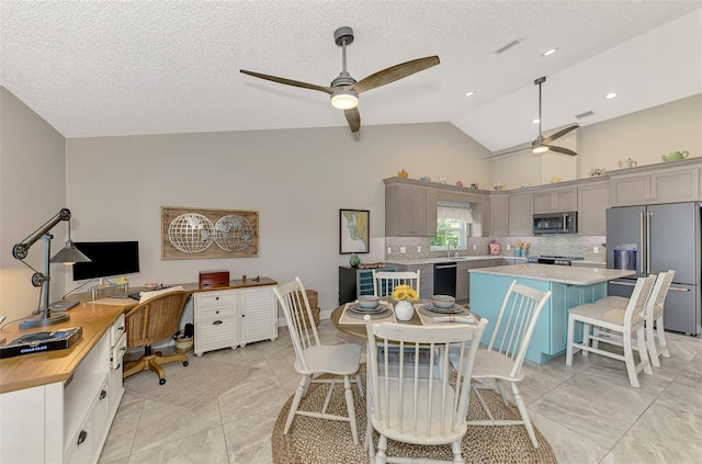 tiled dining room with lofted ceiling, sink, a textured ceiling, and ceiling fan