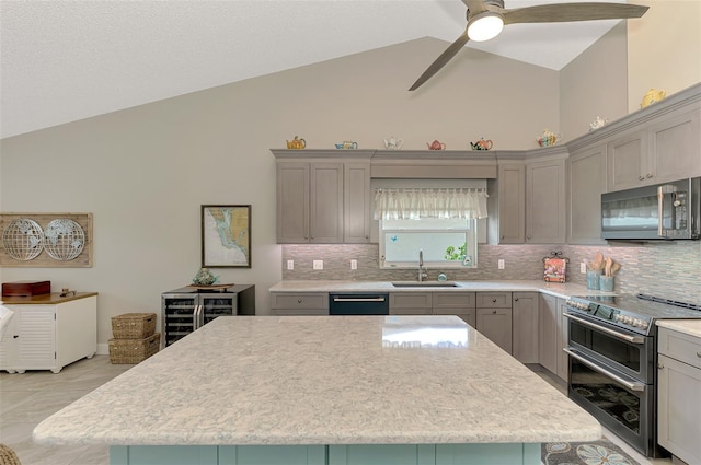 kitchen with backsplash, a kitchen island, stainless steel appliances, and high vaulted ceiling