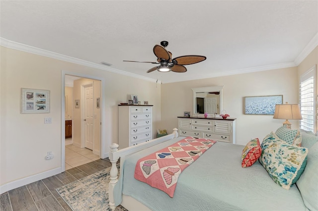 bedroom with ornamental molding, light wood-type flooring, and ceiling fan