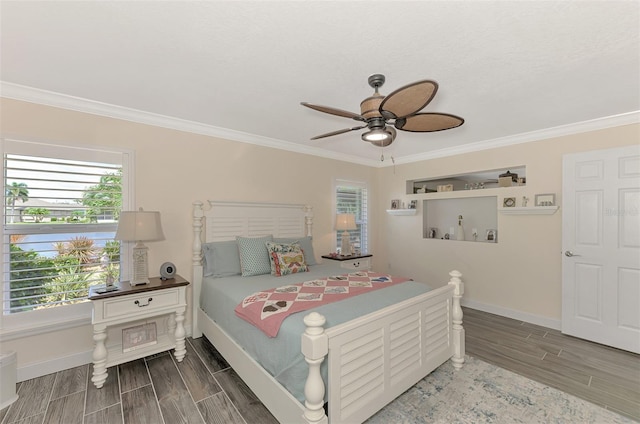 bedroom featuring ceiling fan, ornamental molding, and hardwood / wood-style floors