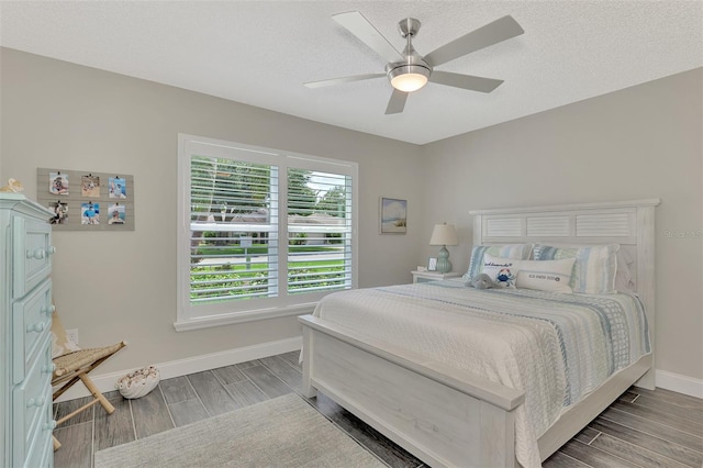 bedroom featuring a textured ceiling, hardwood / wood-style flooring, and ceiling fan