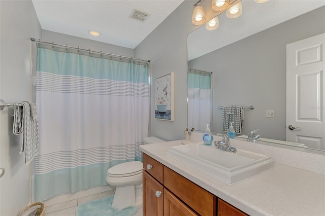 bathroom with tile patterned floors, toilet, vanity, a textured ceiling, and walk in shower