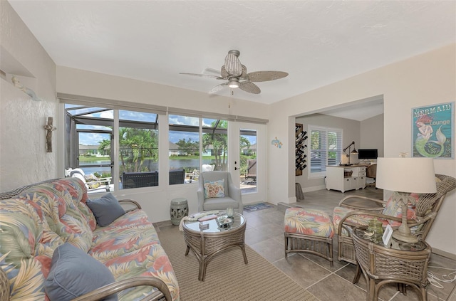 living room with light tile patterned floors and ceiling fan