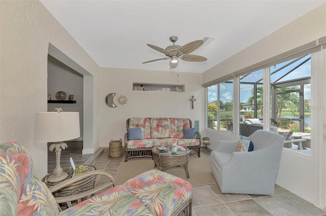 tiled living room with plenty of natural light and ceiling fan