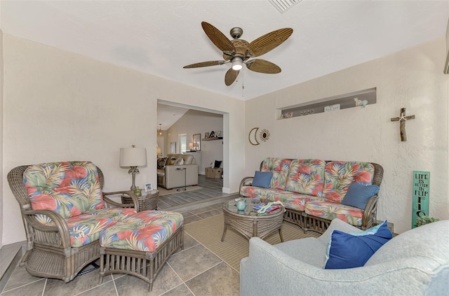 tiled living room with lofted ceiling and ceiling fan