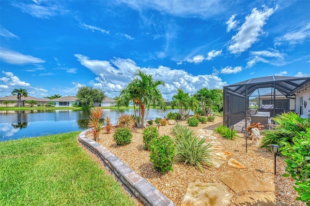 view of yard featuring a lanai and a water view