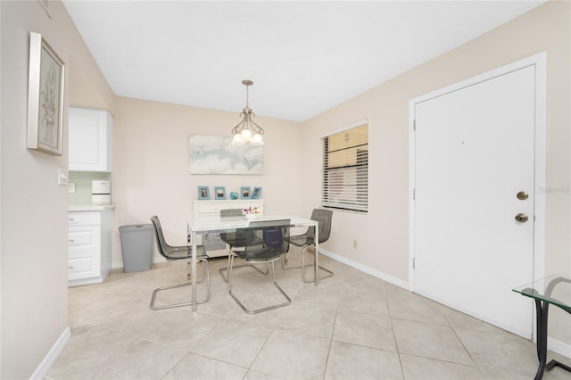 tiled dining space featuring a chandelier