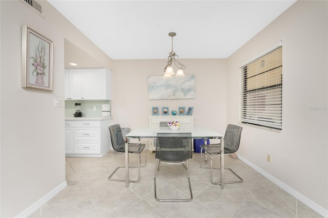 dining space featuring a chandelier and light tile patterned floors