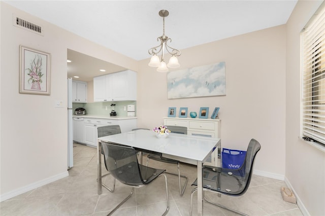 dining space with a notable chandelier and light tile patterned floors