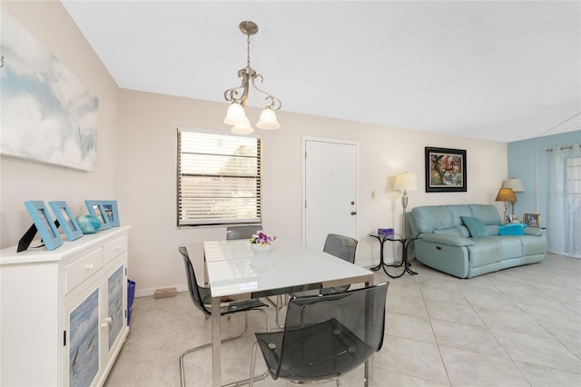 dining room with a chandelier and light tile patterned floors