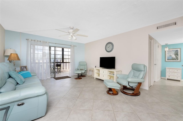 living room with ceiling fan and light tile patterned floors