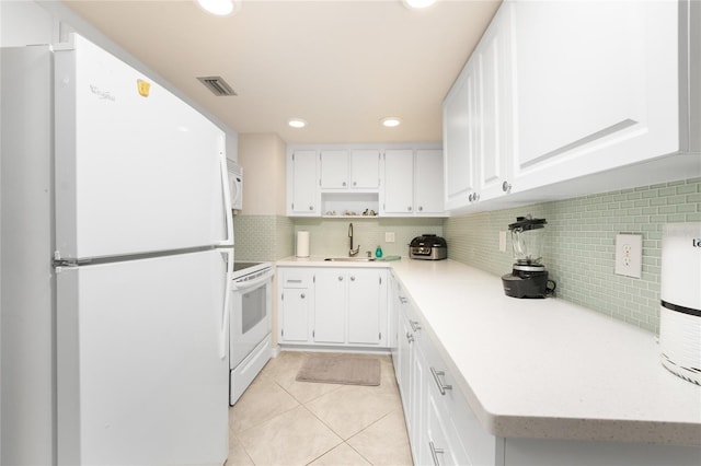 kitchen with white appliances, sink, backsplash, white cabinets, and light tile patterned floors