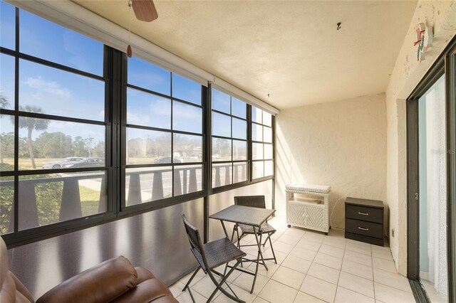 sunroom / solarium featuring ceiling fan