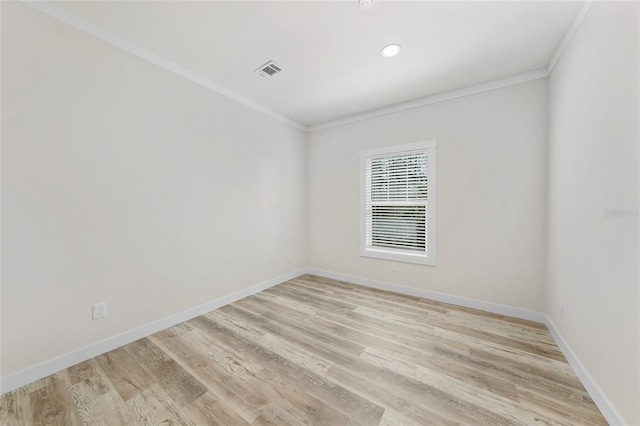 empty room with light hardwood / wood-style flooring and ornamental molding