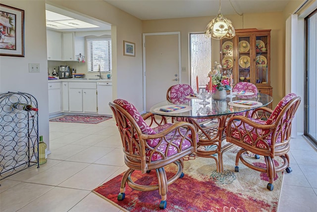 dining area featuring light tile patterned flooring and sink