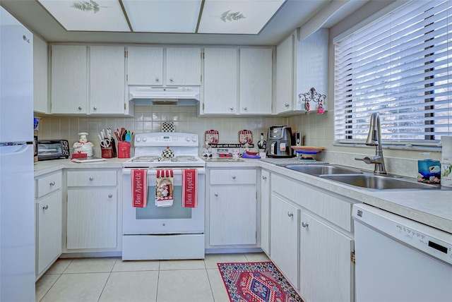 kitchen with sink, white cabinets, and white appliances